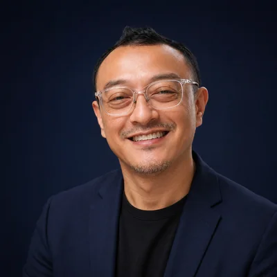 Sufi Rafa'ee, founder of Kultura, wearing a navy blazer against a navy background.